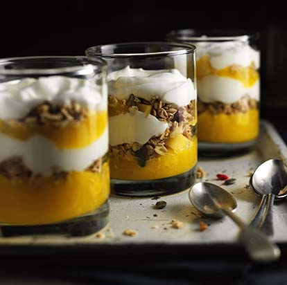 Three glasses of granola, yoghurt and mango fruit prep